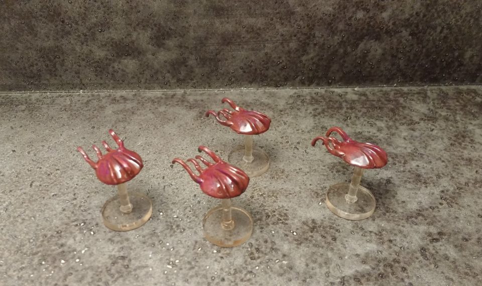 A swarm of octilion starships from Studio Bergstrom painted red and purple.
